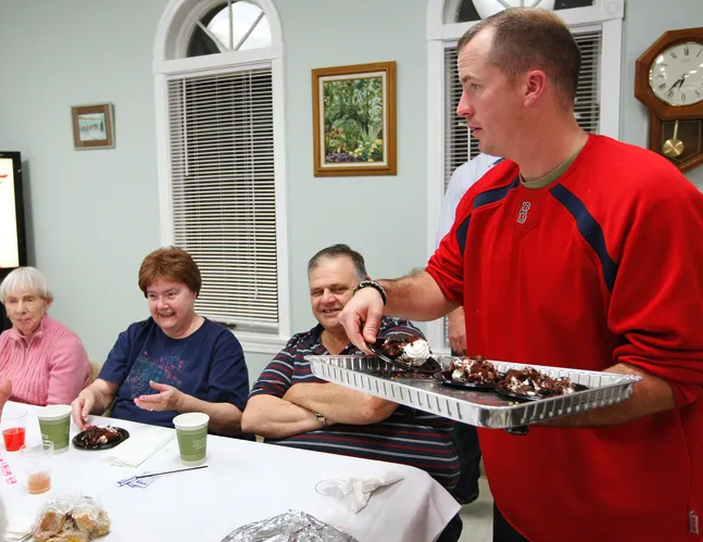 Bridgewater Police Officer matt Lynch jokes with guests as he passes out desserts during the annual dinner for seniors in 2010.