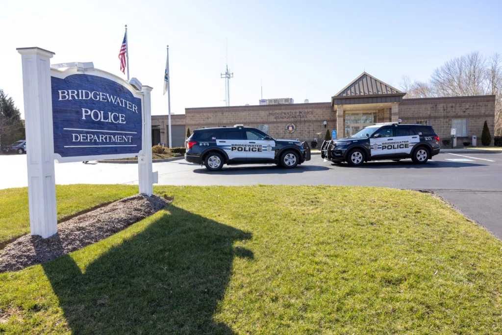 Two police cruisers face each other parked outside of the Bridgewater Police Department headquarters.