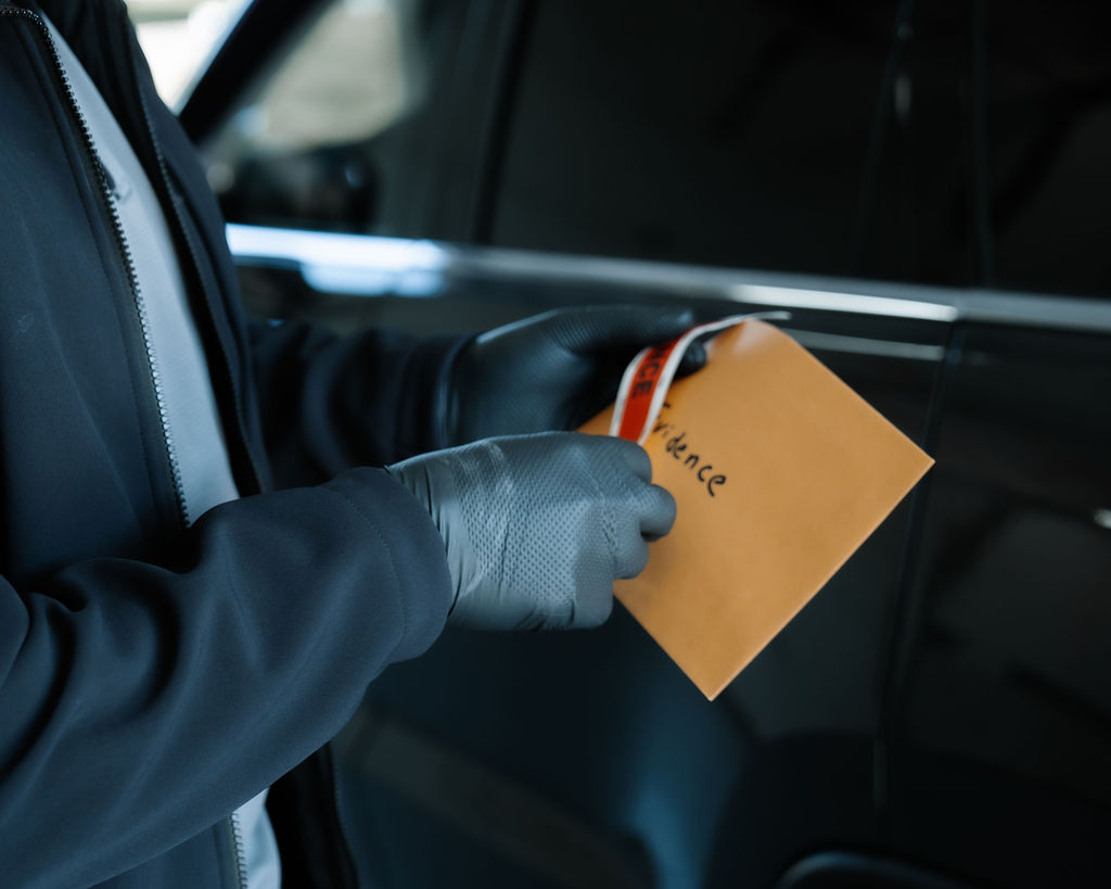 Three police officers stand in the hallway at the Bridgewater Police Department headquarter.